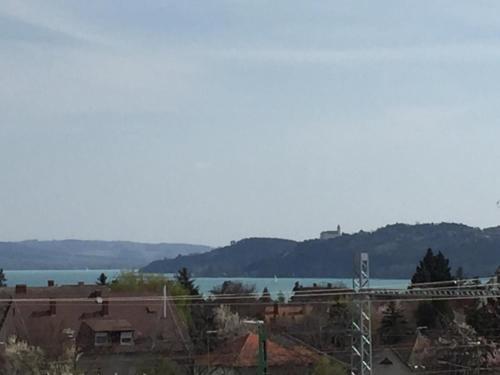 a view of a large body of water with a bridge at Szeki Apartman in Balatonfüred