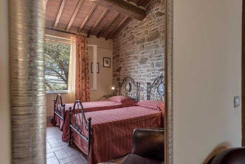 Кровать или кровати в номере Villa Bellaria Lucignano