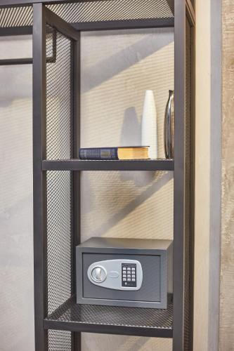 a glass cabinet with a microwave on a shelf at Stixiya in Odesa
