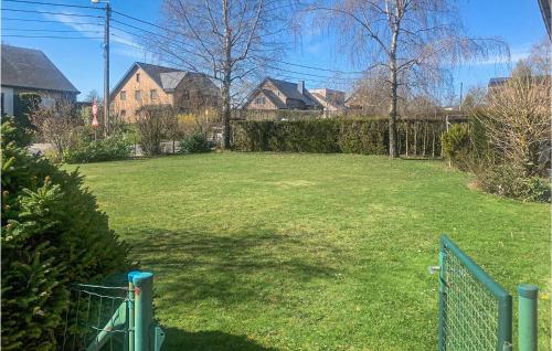 a yard with a fence and some houses at Awesome Apartment In Bastogne in Bastogne