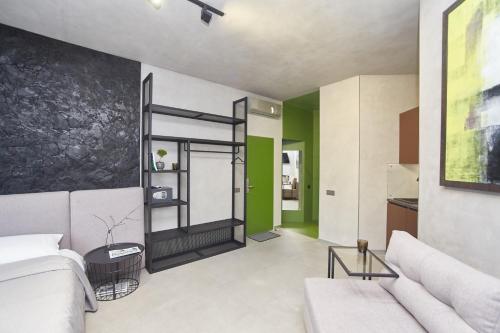 a living room with a white couch and green walls at Stixiya in Odesa