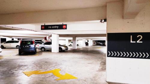 an empty parking garage with cars parked in it at Mevin Woodsbury Suite Butterworth Penang in Butterworth