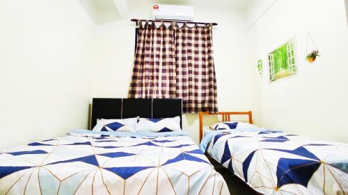 a bedroom with two beds and a window at Mevin Woodsbury Suite Butterworth Penang in Butterworth
