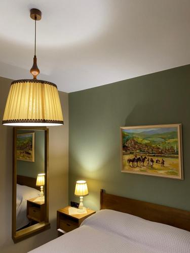 a bedroom with a bed and a large mirror at Guesthouse Tershana in Peshkopi