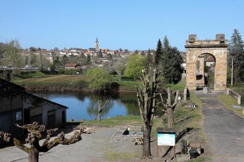 a building next to a river with a bridge at Le Pont de Livinhac in Decazeville