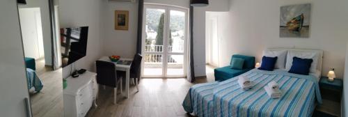 a bedroom with a bed with two cats laying on it at Meridiens in Dubrovnik