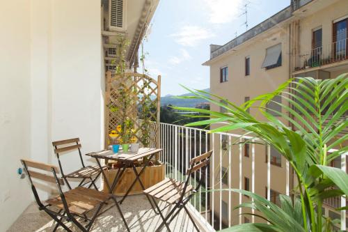a patio with two chairs and a table on a balcony at SorrentoVibes - Luxury Four Bedroom Home with Amazing Terraces in Sorrento in Sorrento