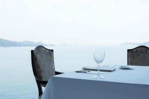 a table with a wine glass sitting on top of it at Toba International Hotel in Toba