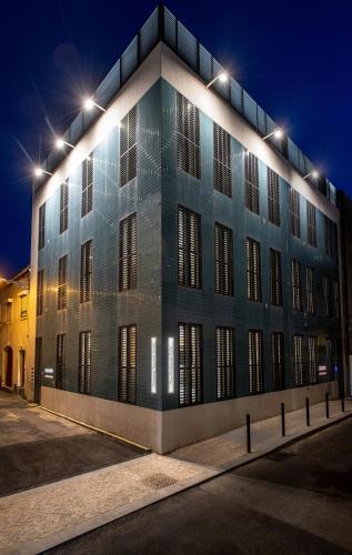 a building with lights on top of it at night at Alcântara Factory I in Lisbon