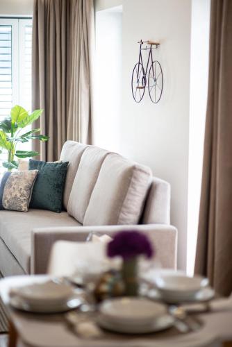 a living room with a couch with a bike on the wall at Alcântara Factory I in Lisbon