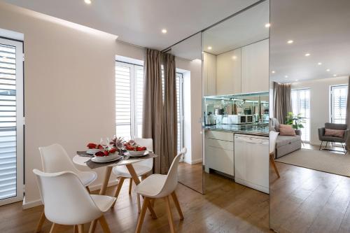 a kitchen and living room with a table and chairs at Alcântara Factory I in Lisbon