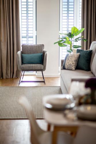 a living room with a couch and a chair at Alcântara Factory I in Lisbon