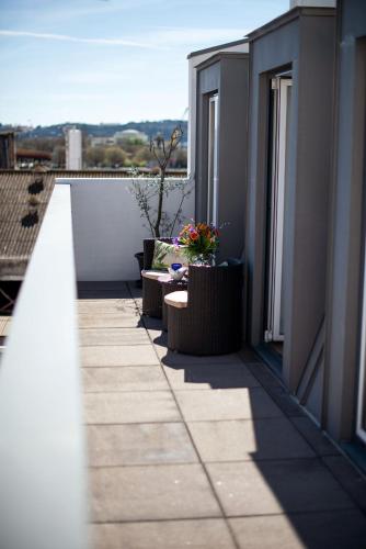 a balcony with a table and flowers on a building at Alcântara Factory I in Lisbon