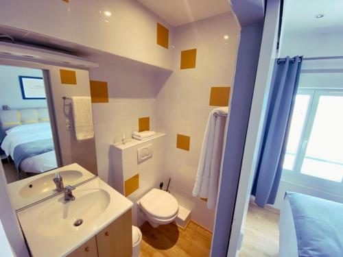 a bathroom with a sink and a toilet at HOTEL RESTAURANT LA COTE REVEE in Leucate