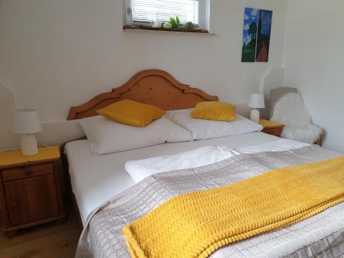 a bedroom with two beds with yellow pillows on them at Hofstätter Ferienwohnung in Fliess