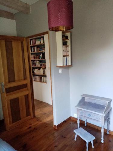 a room with a table and a book shelf at La Canopée in Barret-sur-Meouge