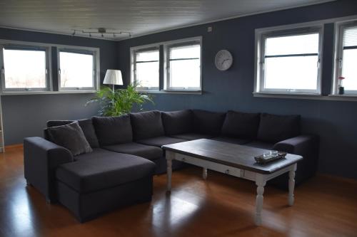 a living room with a couch and a coffee table at Apartment with a view close to The Pulpit Rock in Jørpeland