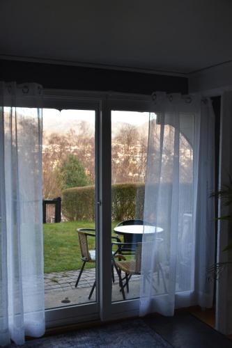 a sliding glass door with a table and a patio at Apartment with a view close to The Pulpit Rock in Jørpeland