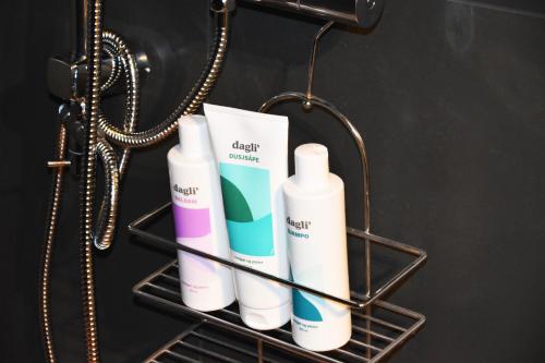 a rack with four bottles of disinfectants on it at Apartment with a view close to The Pulpit Rock in Jørpeland