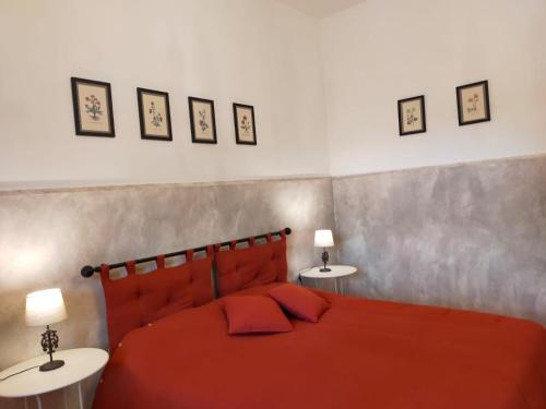a bedroom with a red bed with two tables at La Dependance b&b in Campobasso