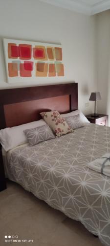 a bedroom with a bed with two pillows on it at Bevs ground floor Roda Golf Apartment! in San Javier