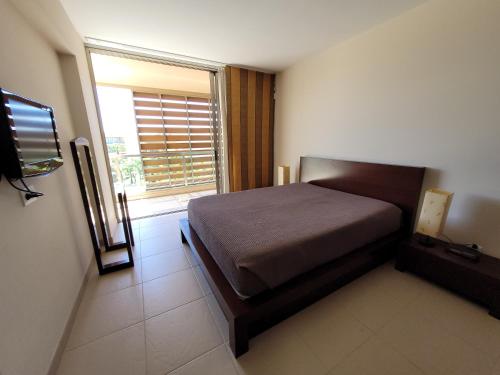 a bedroom with a bed and a window at Apartamento T1 Herdade dos Salgados in Albufeira