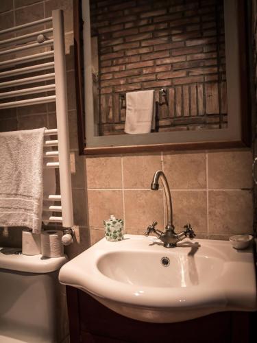 a bathroom with a sink and a toilet at Castillo de Añón de Moncayo in Añón