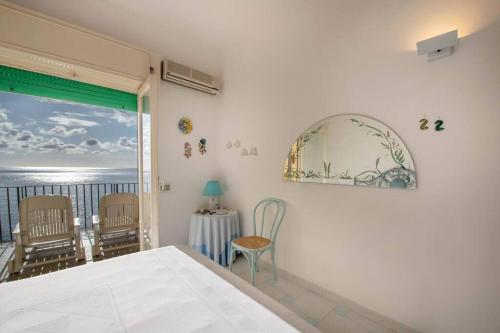 a bedroom with a bed and a view of the ocean at La Casa del Mare in Nerano