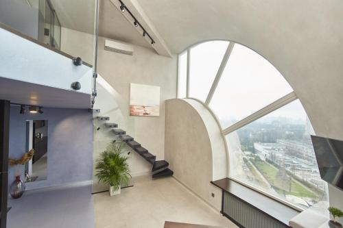 an arched window in a building with a staircase at Stixiya in Odesa