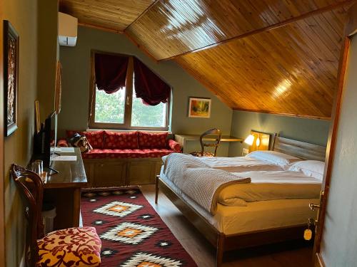 a bedroom with a bed with a wooden ceiling at Guesthouse Tershana in Peshkopi