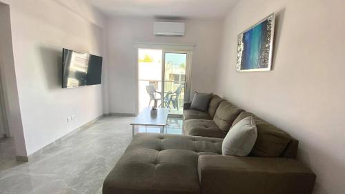 a living room with a couch and a table at Napa Court 2 in Ayia Napa