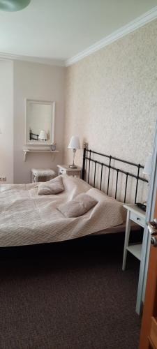 a bedroom with a large bed and a mirror at Villa Shafaly in Mariánské Lázně
