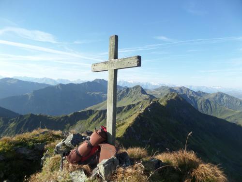 a wooden cross on the top of a mountain at Pension Seighof in Saalbach Hinterglemm
