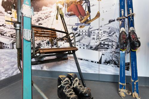 a ski lift with skis and skis on a wall at Pension Seighof in Saalbach Hinterglemm