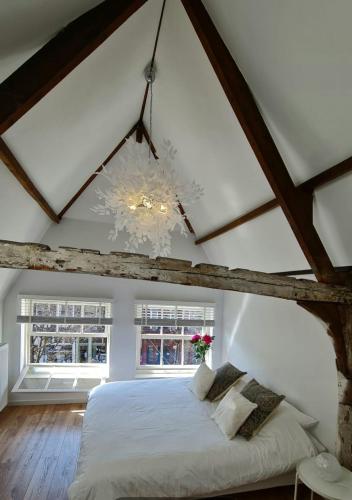 a bedroom with a large bed in a attic at Appartement Mes Amis Delft in Delft