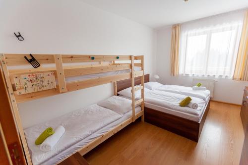 a bedroom with two bunk beds and a window at Ski IN-OUT Apartmán Donovaly in Donovaly