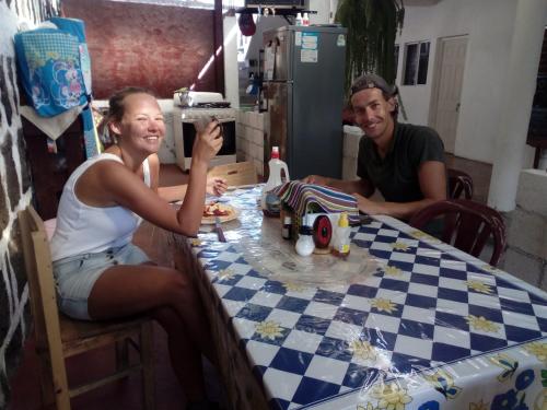 a man and a woman sitting at a table at Casa LLEMO in San Pedro La Laguna