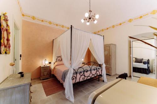 a bedroom with a bed with a canopy at Come Nelle Favole the Classic B&B in Toirano