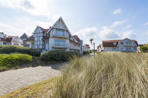 a large house sitting on top of a beach at EastDune in Oostduinkerke