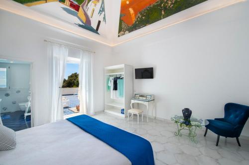 a bedroom with a bed and a table and a chair at Terrazza Zaffiro in Positano