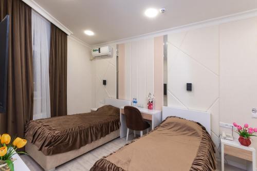Postel nebo postele na pokoji v ubytování Tantana Hotel