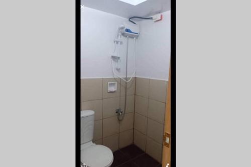 a bathroom with a toilet and a shower at AFFORDABLE BUDGET FRIENDLY STUDIO UNIT in Cebu City