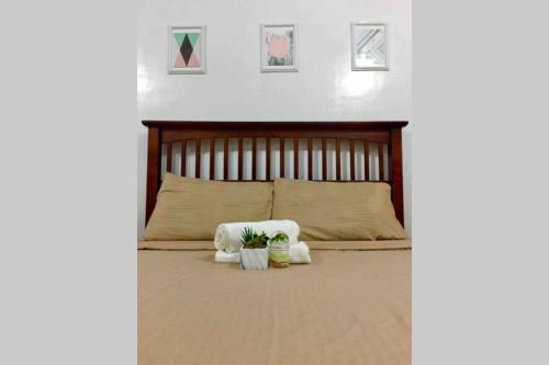 a bedroom with a bed with two white towels at AFFORDABLE BUDGET FRIENDLY STUDIO UNIT in Cebu City