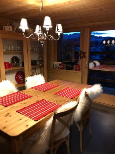 a dining room with a wooden table with furry chairs at CHEZ FOLLO in Mase