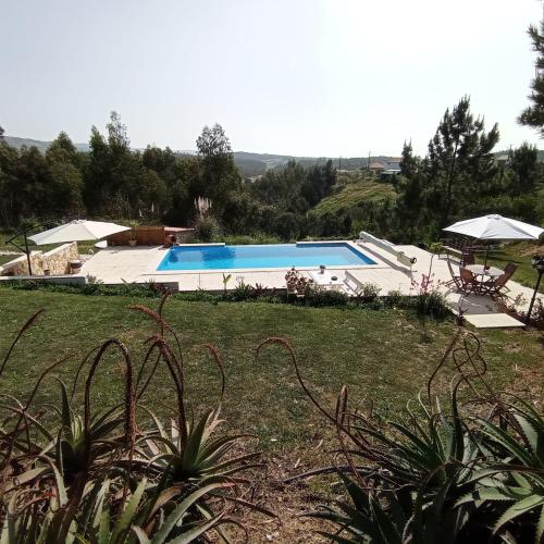 a view of a swimming pool in a yard at Moinho da Amélia in Cadaval