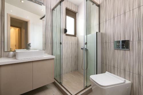 a bathroom with a shower and a toilet and a sink at Onirico House in Rhodes Town