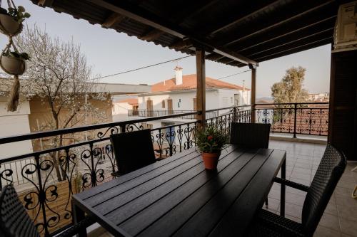 a wooden deck with a table and chairs on a balcony at AIORA yard in Ammouliani