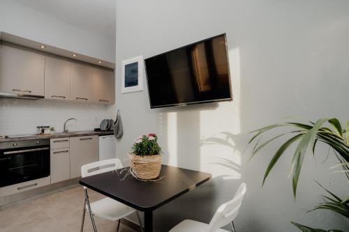 a kitchen with a table with a potted plant on it at AIORA yard in Ammouliani