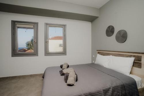 a bedroom with a bed with a stuffed animal on it at AIORA yard in Ammouliani