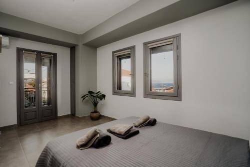 a bedroom with a bed with two pillows on it at AIORA yard in Ammouliani
